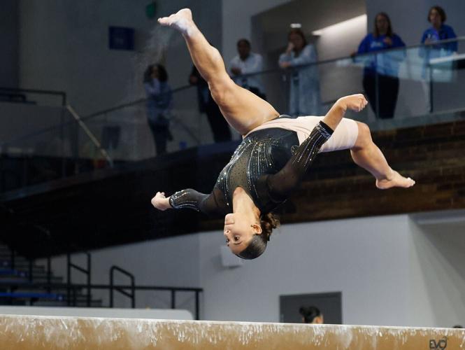 Amy Wier does a front aerial on beam at the NCAA Lexington Regional