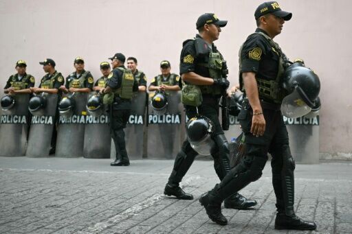 Peruvian police officers stand guard before the election of a new interim president