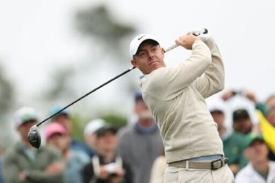 Defending champion and world number two Rory McIlroy of Northern Ireland plays a tee shot during a practice round for the 90th Masters at firm and fast Augusta National