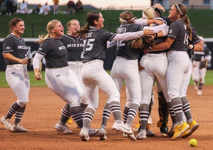 Mizzou pitcher Marissa McCann (10) is mobbed by her teammates