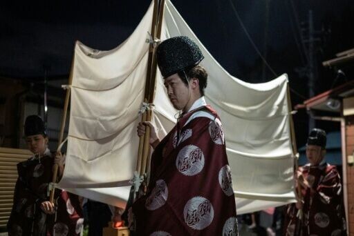 The centuries-old festival sees Shinto priests lead a procession to a sacred shrine at the summit