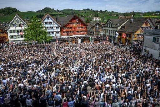 Appenzell Innerrhoden citizens vote by raising their right hand during the Landsgemeinde open-air assembly
