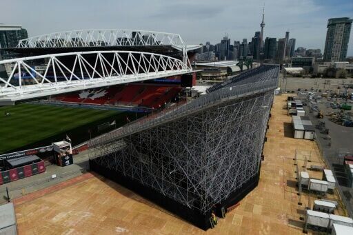 Workers assembling temporary bleacher seating at BMO Field in Toronto