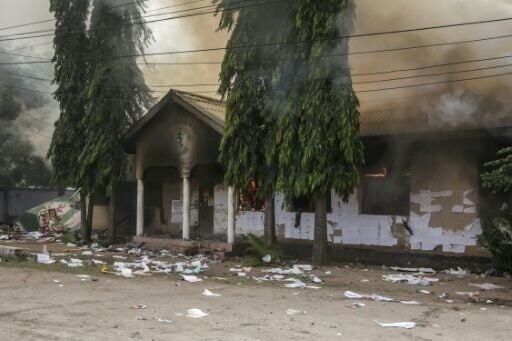 A polling station is set ablaze as clashes erupt in Dar es Salaam on October 29, 2025