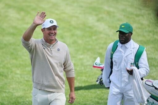 Two-time US Open champion Bryson DeChambeau waves alongside actor and Par-Three Contest caddie Kevin Hart on the eve of the 90th Masters at Augusta National