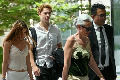 French teenager Didier Gaspard Owen Maximilien (2nd L) faces criminal charges in Singapore for a straw licking stunt
