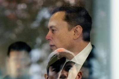 Elon Musk is seen through glass at the Ronald V. Dellums US Courthouse in Oakland, California,