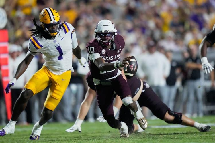 Texas A&M quarterback Marcel Reed (10) tries to elude