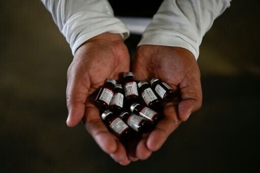 A health ministry worker showing vaccine doses for an immunisation campaign in Guatemala