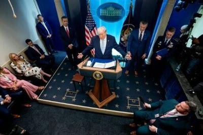 US President Donald Trump -- accompanied by CIA Director John Ratcliffe (C-L), Secretary of Defense Pete Hegseth (2nd-R) and Chairman of the Joint Chiefs of Staff General Dan Caine (R) -- speaks during a news conference at the White House on April 06, 2026
