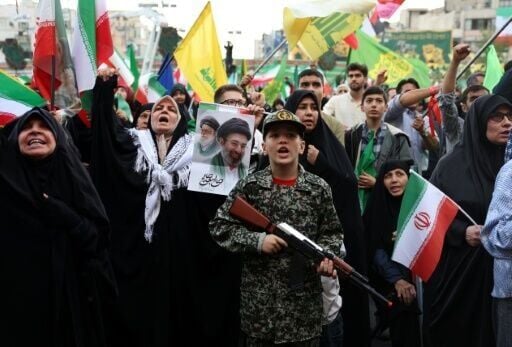 Supporters of new Iranian supreme leader Ayatollah Mojataba Khamenei stage a rally