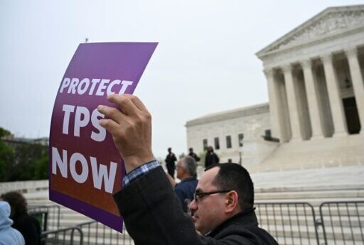 A protestor outside the US Supreme Court as the court weighs ending temporary protected status for Haitians and Syrians