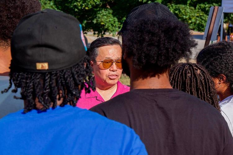 Attendees at the annual Welcome Black & Gold BBQ speak to UM System President Mun Choi