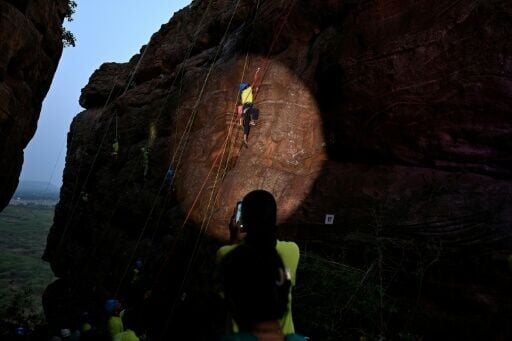 A climber scaling a rock wall in the Indian state of Karnataka