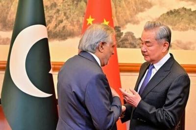 This handout photograph taken on March 31 and released by Pakistan's Ministry of Foreign Affairs shows China's Foreign Minister Wang Yi (right) speaking with his Pakistani counterpart Ishaq Dar in Beijing