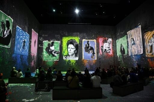 People attend the multimedia show 'David Bowie: You're Not Alone', showcasing work from the British musical legend