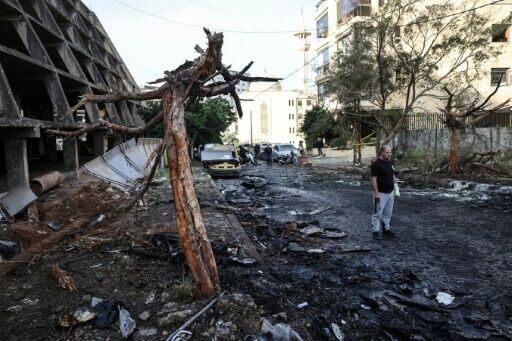 A man stands at the site of an Israeli strike in Beirut
