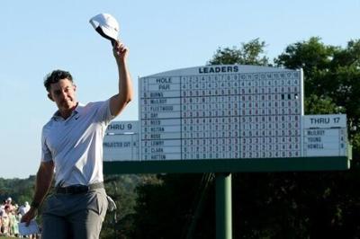 Defending champion Rory McIlroy tips his cap to spectators at the 18th hole after seizing the largest 36-hole lead in Masters history of six strokes