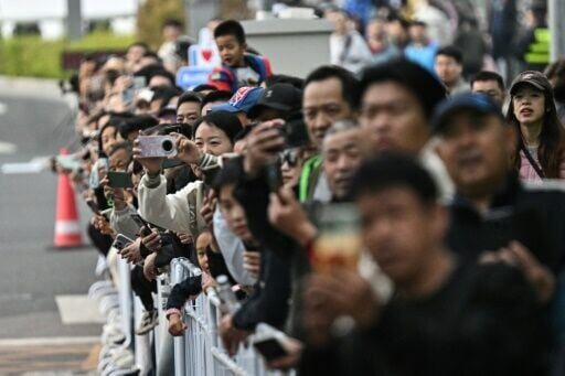 Curious spectators lined the roads to watch the machines and their human rivals race at the half marathon in Beijing