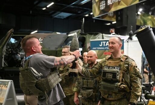 A visitor at the fitness fair showed off his muscles by lifting a mortar shell at the Bundeswehr's recruiting stand
