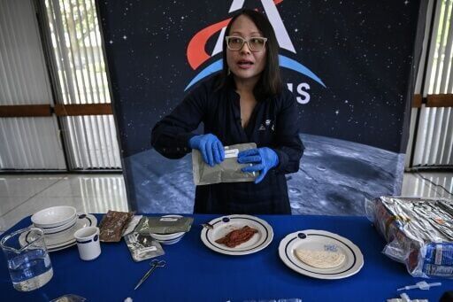 Xulei Wu, a NASA food scientist, displays dishes that were part of the Artemis II crew's meals