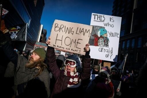 People hold signs in reference to five-year-old Liam Conejo Ramos who was held by immigration officers, during the "ICE out of Minnesota: Day of Truth and Freedom" protest in Minneapolis, Minnesota on January 23, 2026