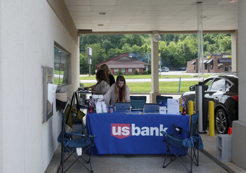 As flooded Neosho bank is renovated, employees help customers outside