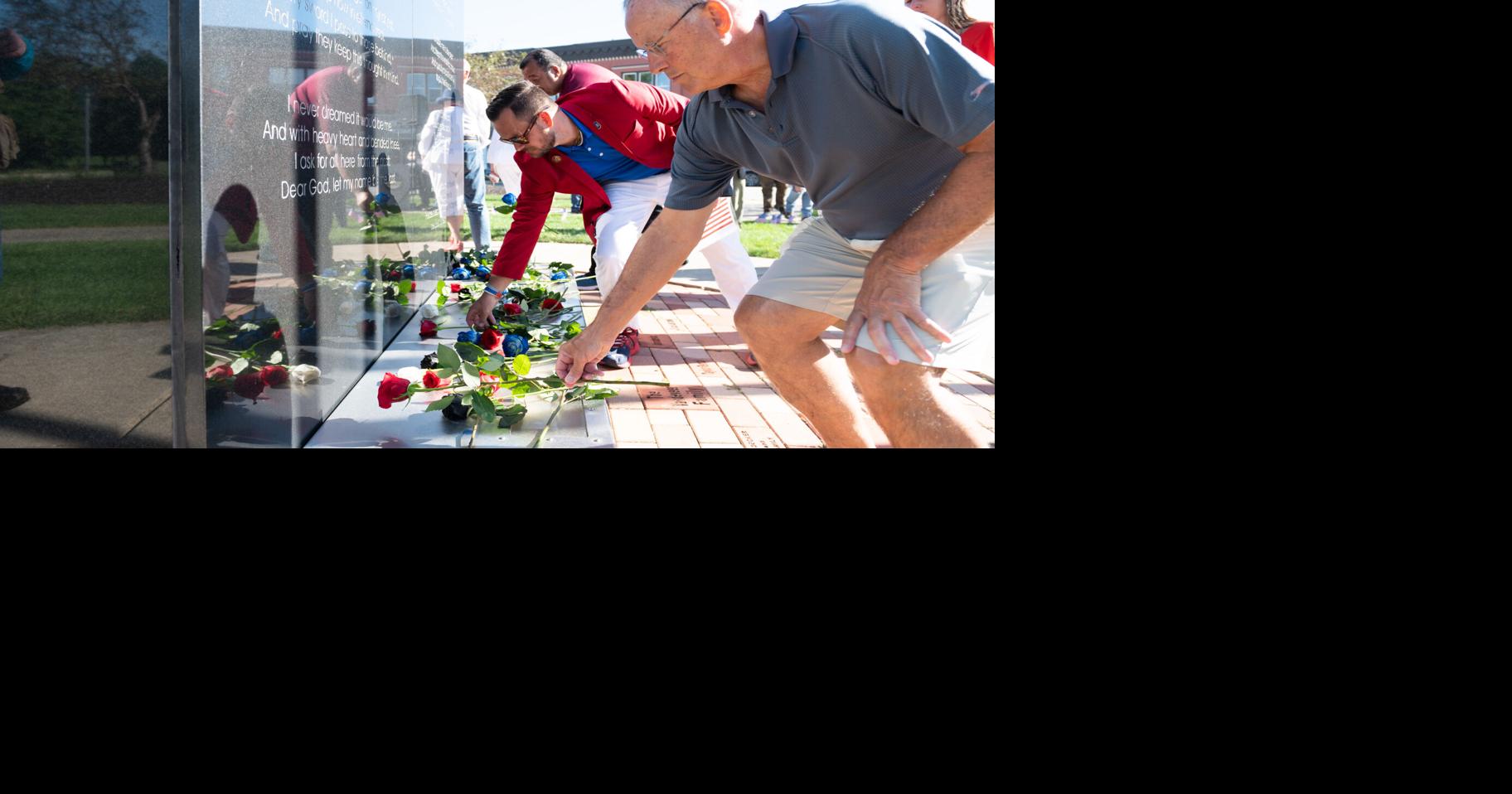 Community members lay roses, plant flags to honor those lost on Sept. 11, 2001
