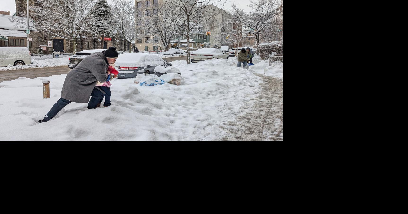 More snow falls on the Northeast, where huge piles remain from the last storm