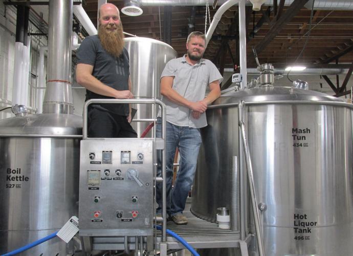 Matt Gohring (left) and Adam Holmberg check Code Beer's boil kettle and mash tun