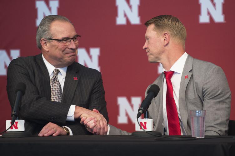 Bill Moose shakes hands with Scott Frost