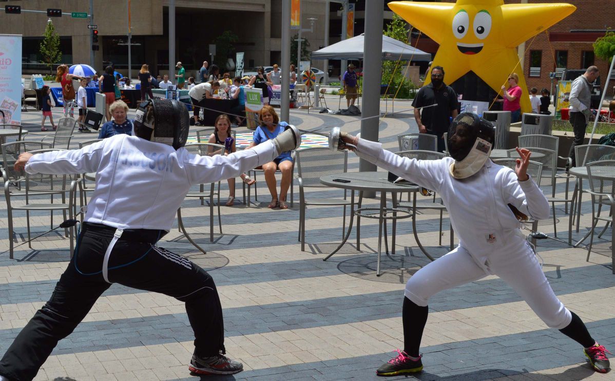 Members of the Lincoln Fencing Club give a demonstration at Tower Square