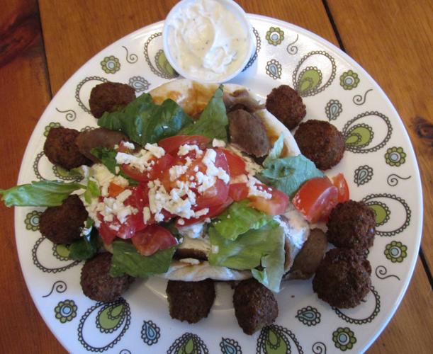 Gyro and pita surrounded by falafel