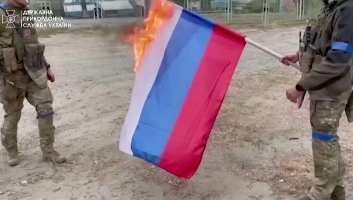 Ukrainian soldiers burn Russian flag in Vovchansk as they regain territory  