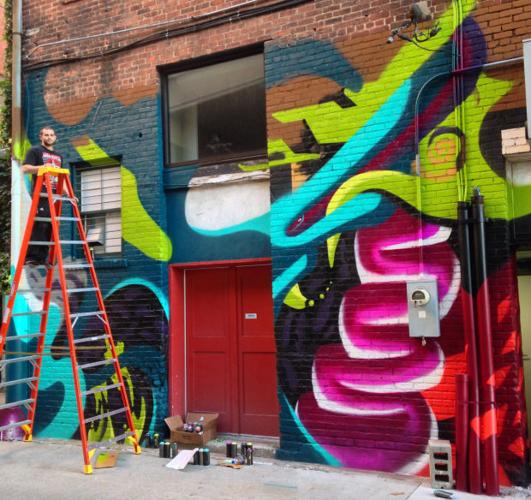 Pacheco works on mural at Kiechel