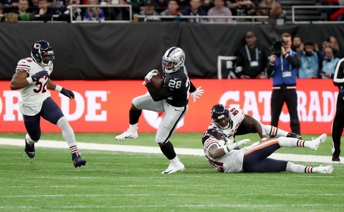 Oakland Raiders running back Josh Jacobs (28) breaks free from the Chicago Bears defense in the first quarter against the Oakland Raiders on October 6, 2019, at Tottenham Hotspur Stadium in London.