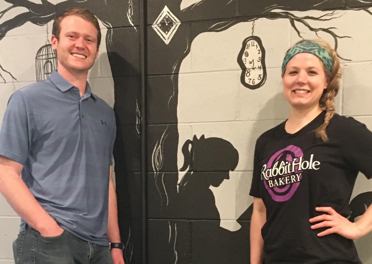 Beau Ballard and Amanda Fuchser by Alice in Wonderland mural