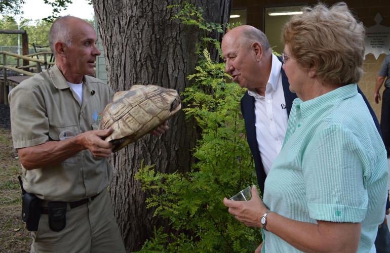 Randy Scheer, animal curator, shows leopard tortoise to Larry & Carol Hudkins