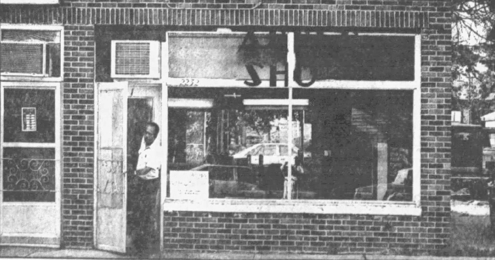 Wade s Barber Shop and the black man behind the red chair creating