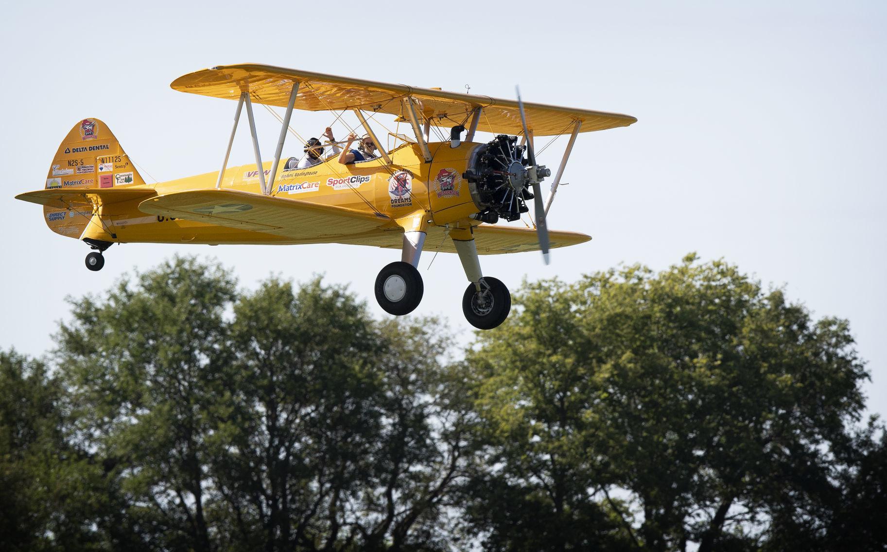 A crop duster in a World War II trainer plane gives the rides of his