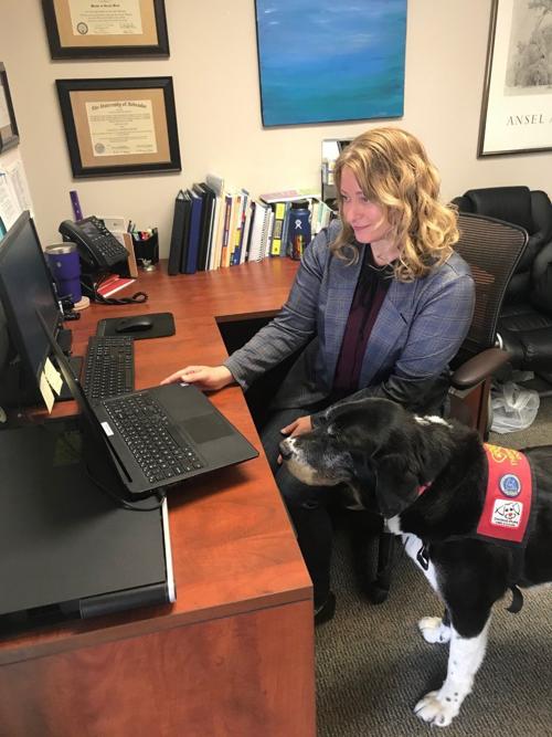Jackie Prater and George the therapy dog provide telehealth