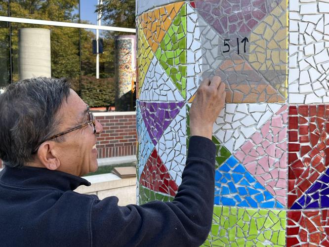 Ceramicist Eddie Dominguez works on a mosaic column