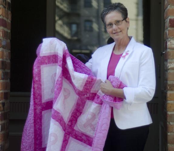 Cindy Poeschl with quilt