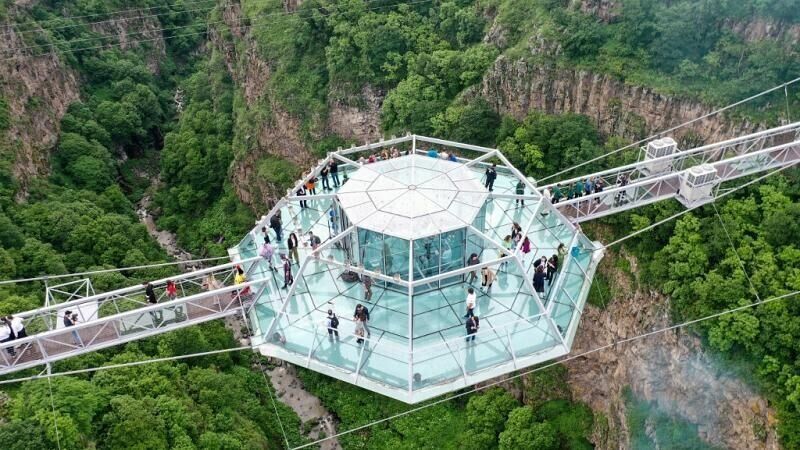 Tourists flock to 780 foot glass bridge across canyon in country of Georgia