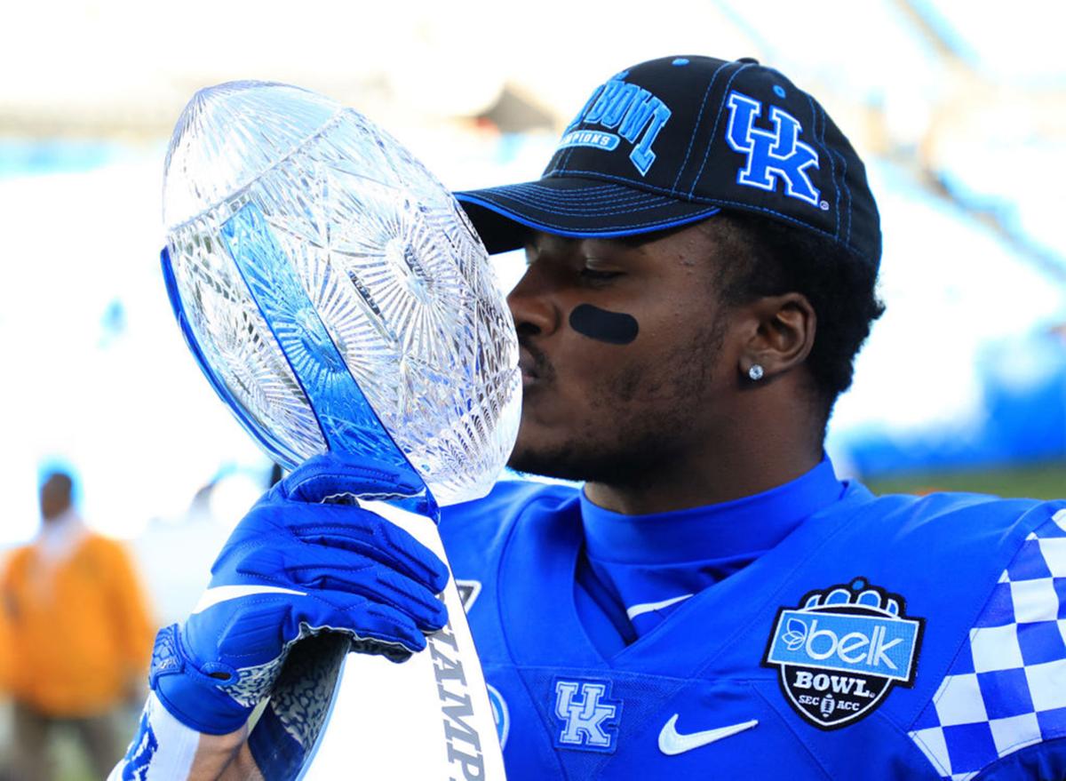 Kentucky's Xavier Peters kisses the Belk Bowl trophy after defeating Virginia Tech, 37-30, at Bank of America Stadium in Charlotte, N.C., on December 31, 2019.