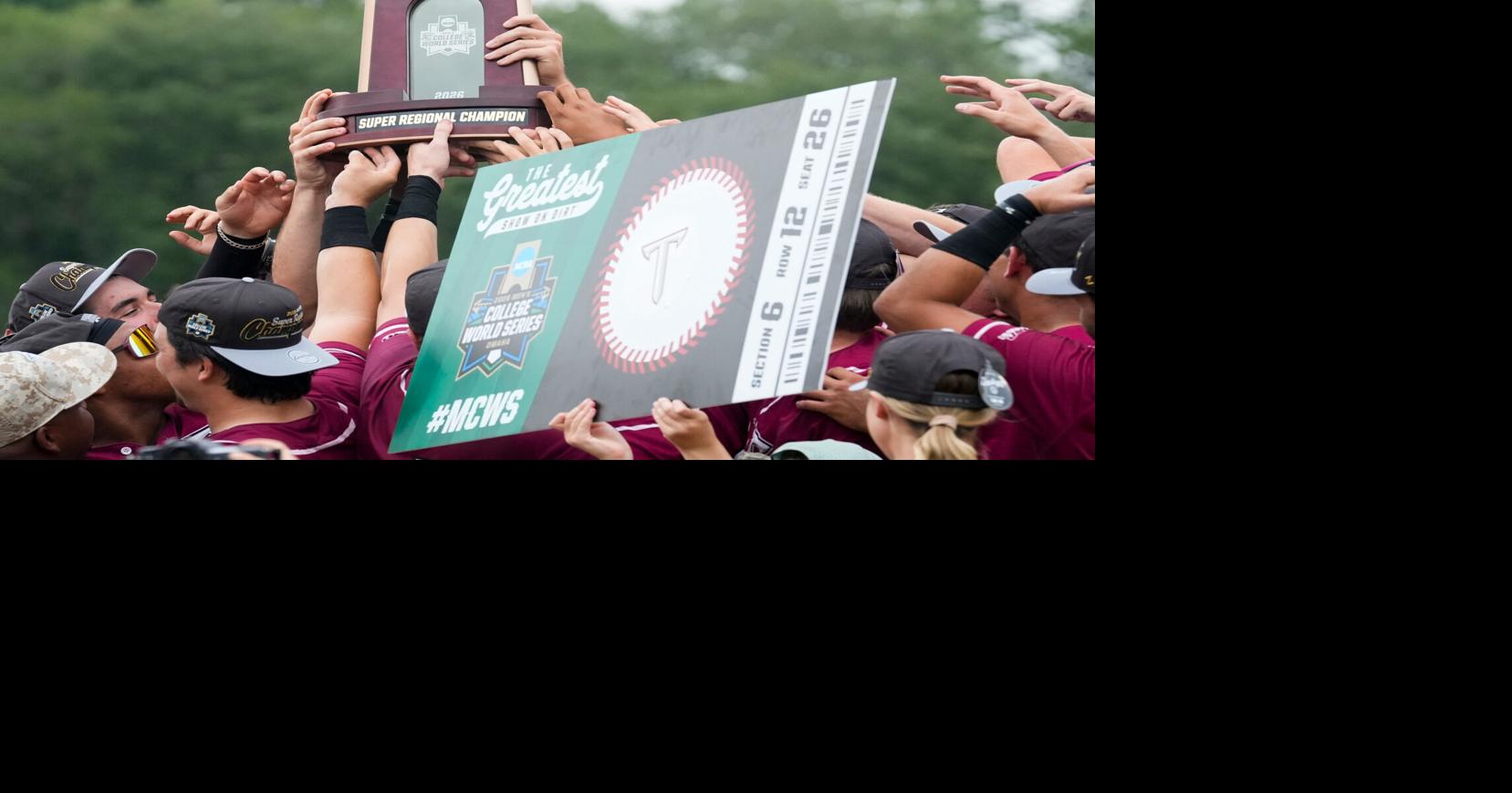 Troy University players hoist their Super Regional Championship trophy and their “ticket” to the College World Series after defeating Arkansas Little Rock during game two of their NCAA Baseball Super Regional on the Troy University campus in Troy, Ala.