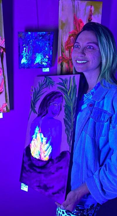 Aimee Booton with black light paintings