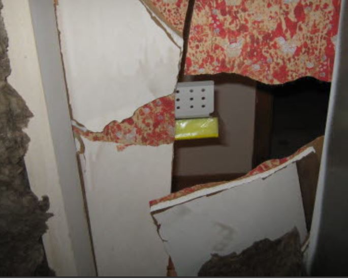 Woman awakes to strangers in her apartment, finds hole in wall, police
