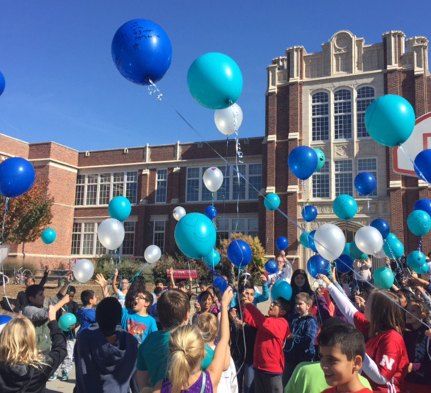 Balloons float into the sky Friday to remember Clinton student who