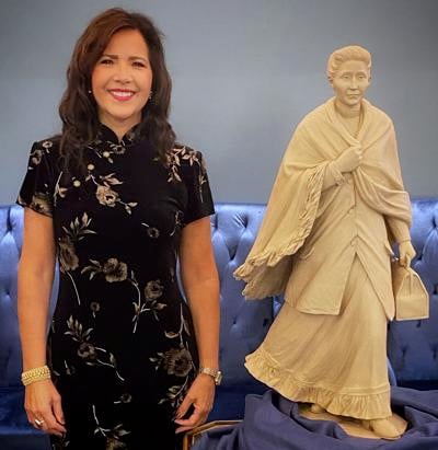 Judi gaiashkibos with maquette of Dr. Susan La Flesche